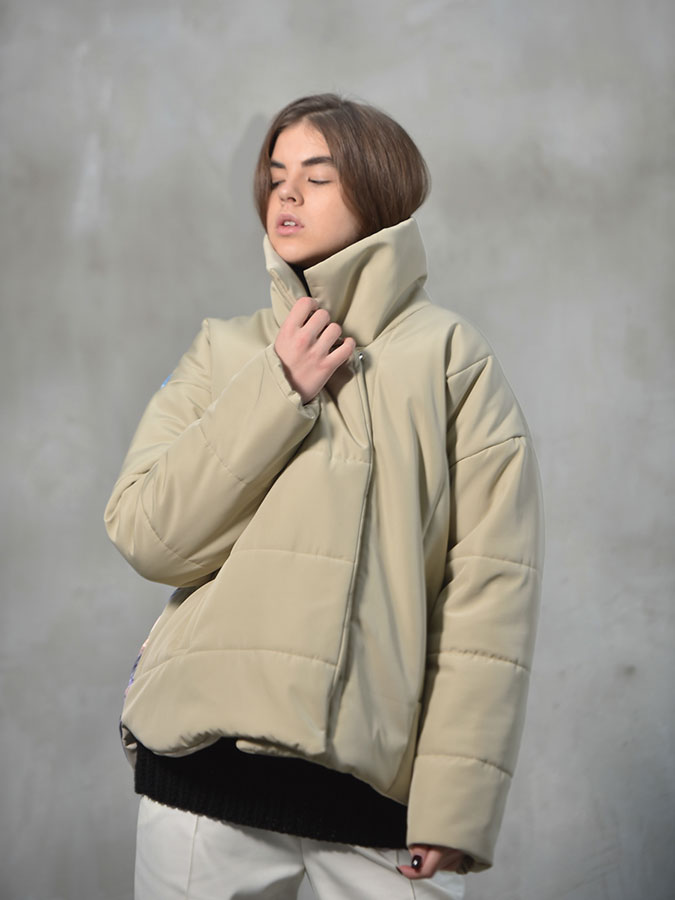 Beige puffer with a vertical print on back