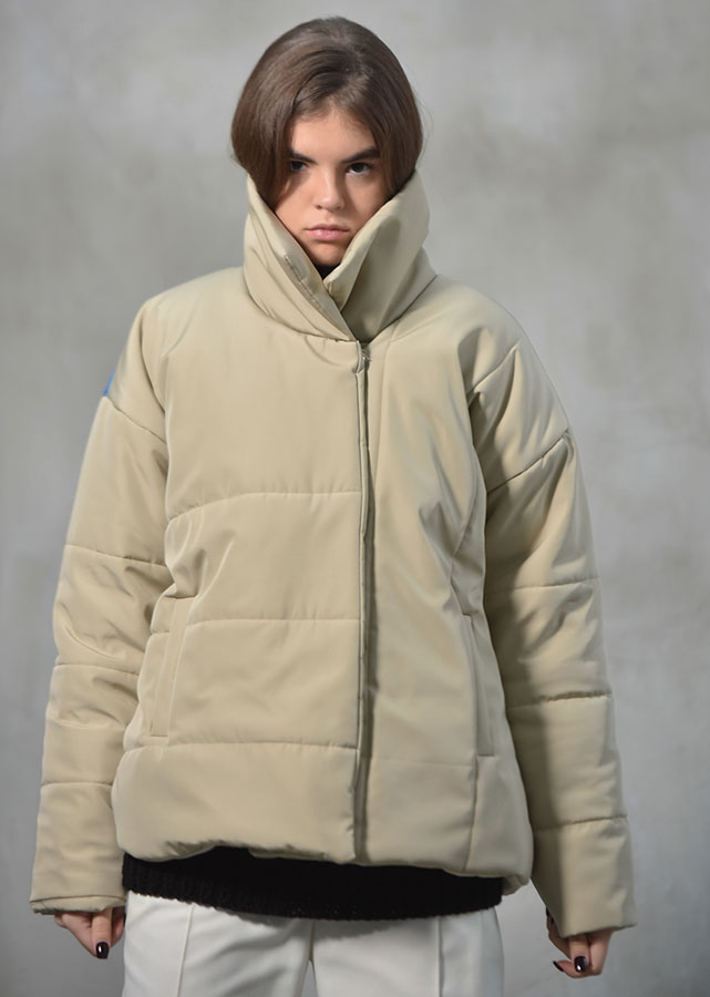 Beige puffer with a vertical print on back
